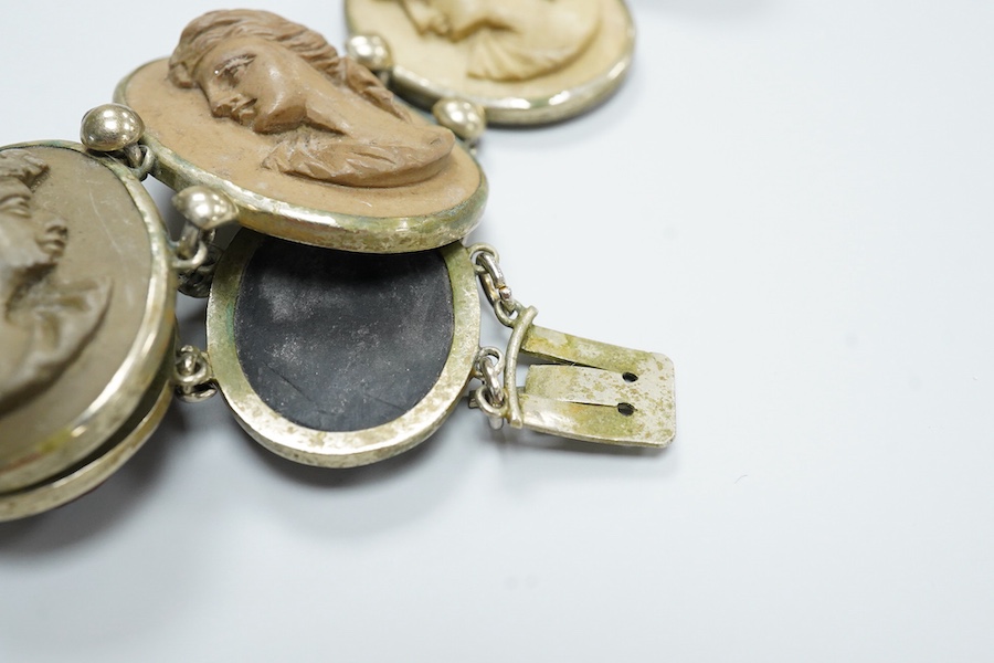 A Victorian base metal bracelet, set with seven graduated lava cameos, carved with the busts of lady's to dexter and sinister, approximately 16.5cm.